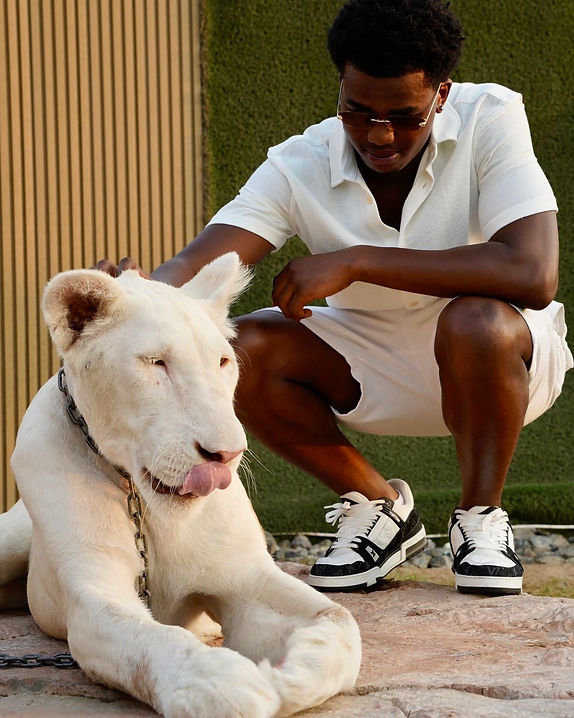 AI E-Com founder crouching beside a white lion